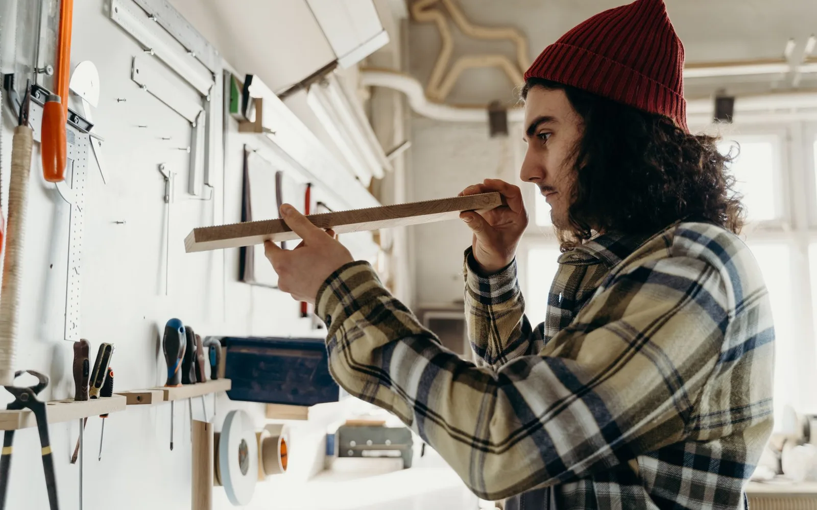 A craftsman at work in a bright workshop — an illustration of the trades Neubor builds for.