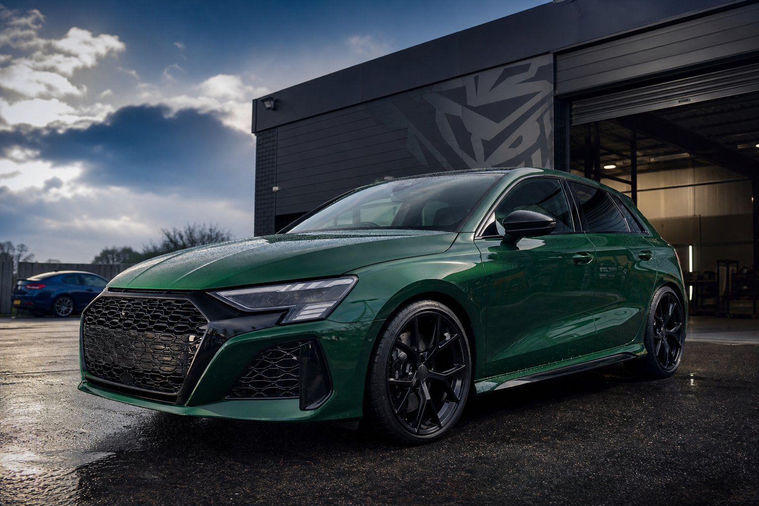 Emerald performance car parked outside an independent garage workshop