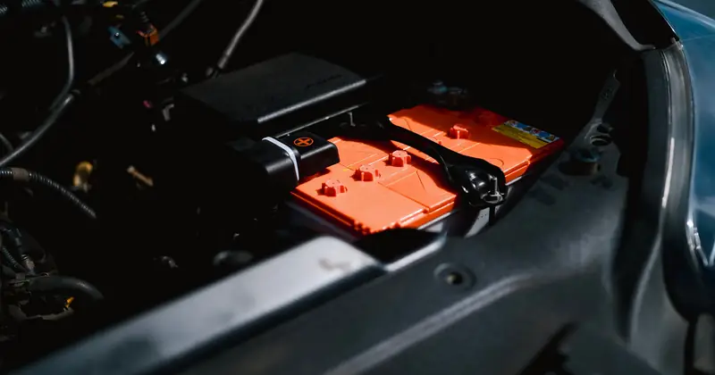 Detailed view of an electric car battery inside a vehicle's engine compartment, highlighting sustainable technology.