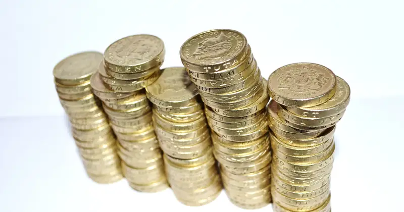 Close-up of stacked gold coins symbolizing wealth and financial growth.