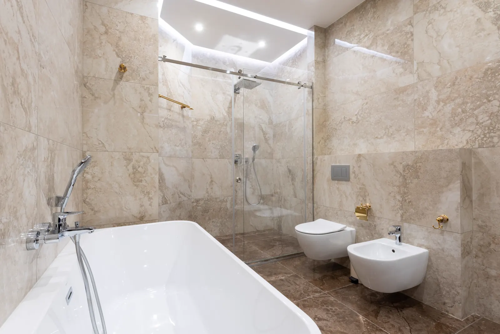 Bright marble bathroom with a clean bath and tiles.
