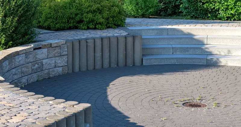 Elegant circular patio with stone steps and lush greenery, Coesfeld, Germany.