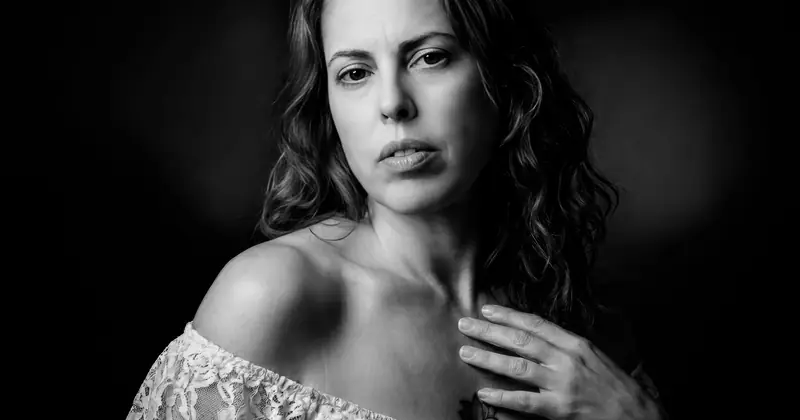 A classic black and white portrait capturing a woman's thoughtful expression.
