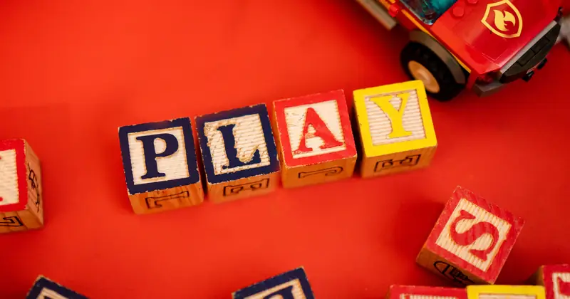 Top view of assorted wooden blocks spread on a wooden floor, creating a playful scene.
