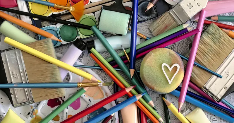 A vibrant assortment of art supplies including paints, brushes, and pencils, featuring a heart motif.
