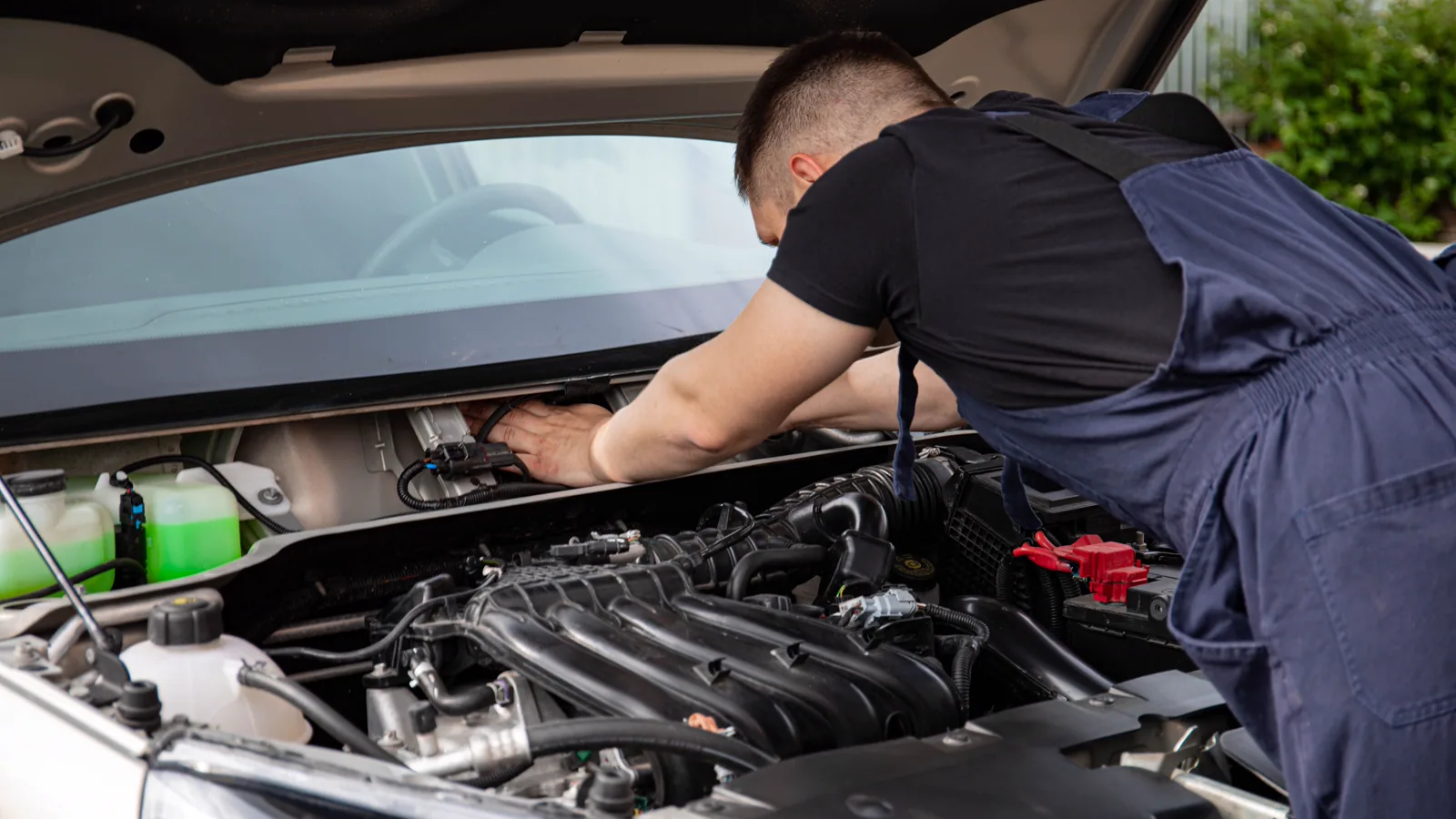 Mechanic inspecting an engine bay