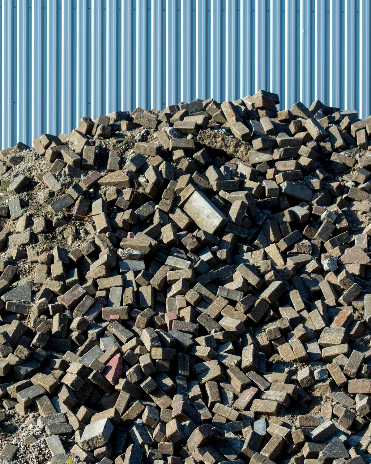 Representative stock image of reclaimed building materials ready for sorting.