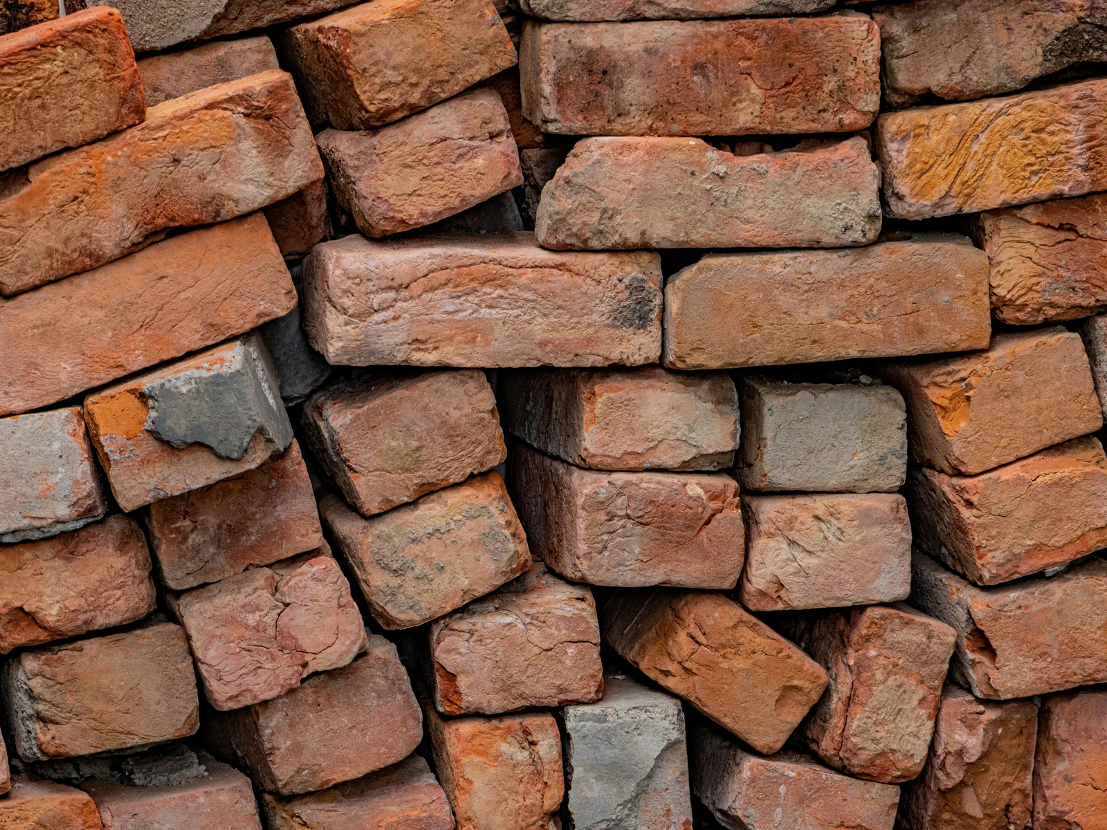 Representative stock image of reclaimed brick and building materials in a yard.
