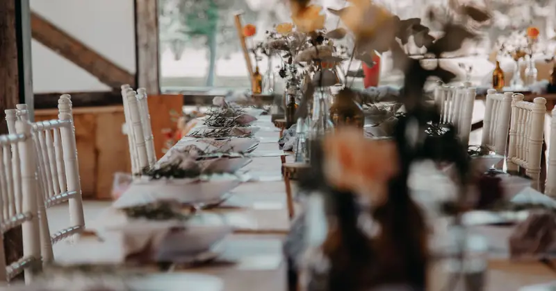 A beautifully set indoor table with floral decor, perfect for weddings or special events.